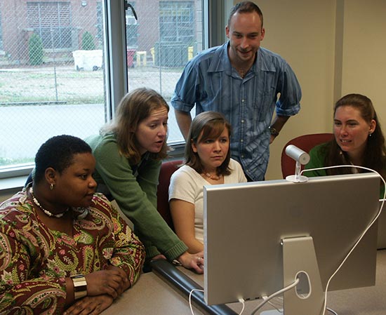 Five New Literacies team members around a computer
